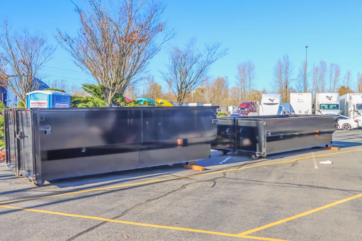 Professional dumpster rental service with roll-off container on residential driveway in Renton